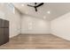Open living space with sleek ceiling fan and modern flooring at 1736 N Ashbrook Cir, Mesa, AZ 85213