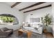 Inviting living room with a large window, comfortable sofa, stylish decor, and ample natural light at 1736 N Ashbrook Cir, Mesa, AZ 85213