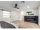 Modern living room with a sliding barn door and a fireplace with a dark marble surround at 1736 N Ashbrook Cir, Mesa, AZ 85213