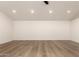 Expansive living room featuring neutral walls and modern wood-look floors at 1736 N Ashbrook Cir, Mesa, AZ 85213