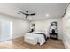 Relaxing main bedroom with neutral tones, a ceiling fan, and sliding door access to the outdoors at 1736 N Ashbrook Cir, Mesa, AZ 85213
