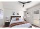 This bedroom features a contemporary design, with wood floors, ceiling fan, and access to outside at 1736 N Ashbrook Cir, Mesa, AZ 85213