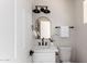Stylish powder room features a modern vanity with matte black accents and a decorative mirror at 1736 N Ashbrook Cir, Mesa, AZ 85213