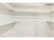 Spacious walk-in closet featuring ample shelving for optimized storage solutions at 1736 N Ashbrook Cir, Mesa, AZ 85213