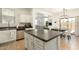 Bright kitchen with an island open to the dining area and a glimpse of the living room at 17613 N 114Th Ln, Surprise, AZ 85378