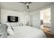 Bright bedroom features an ensuite bathroom, a ceiling fan, and ample natural light at 17613 N 114Th Ln, Surprise, AZ 85378