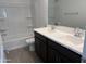 Bathroom featuring double sink vanity, hard surface flooring, and shower/tub combo at 17989 W Lupine Ave, Goodyear, AZ 85338
