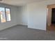 Bedroom featuring plush carpeting, bright natural light, and an open doorway at 17989 W Lupine Ave, Goodyear, AZ 85338