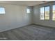 Spacious bedroom featuring neutral carpet and multiple large windows at 17989 W Lupine Ave, Goodyear, AZ 85338