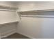 Walk-in closet with installed wood shelves for storage at 17989 W Lupine Ave, Goodyear, AZ 85338