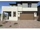 Two-story home featuring a two-car garage and low-maintenance desert landscaping at 17989 W Lupine Ave, Goodyear, AZ 85338