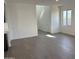 Spacious living area with neutral walls and flooring, stairs, and a window view at 17989 W Lupine Ave, Goodyear, AZ 85338