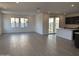 Open-concept living room with tile floors and access to the kitchen and backyard at 17989 W Lupine Ave, Goodyear, AZ 85338