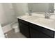 Bright bathroom featuring a double sink vanity with quartz countertop next to a white toilet at 18061 W Lupine Ave, Goodyear, AZ 85338