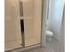 This bathroom features a glass shower door and white tile, next to a white toilet at 18061 W Lupine Ave, Goodyear, AZ 85338