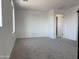 Bright bedroom featuring neutral carpet, white walls, and ample natural light at 18061 W Lupine Ave, Goodyear, AZ 85338