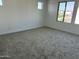 Carpeted room with multiple windows providing lots of natural light at 18061 W Lupine Ave, Goodyear, AZ 85338
