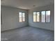 Bright room with tile flooring and large windows at 18061 W Lupine Ave, Goodyear, AZ 85338