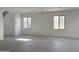 Spacious living room filled with natural light and tile flooring at 18061 W Lupine Ave, Goodyear, AZ 85338