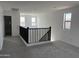 Loft featuring carpeted flooring and a black railing at 18061 W Lupine Ave, Goodyear, AZ 85338