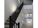 Bright foyer features a staircase with black railing and carpeted steps at 18061 W Lupine Ave, Goodyear, AZ 85338