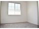 Bright bedroom featuring neutral carpet, base-molding and a large window at 18250 N Cave Creek Rd # 123, Phoenix, AZ 85032