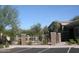 Community pool with lounge chairs surrounded by a secure iron fence and lush landscaping at 18250 N Cave Creek Rd # 123, Phoenix, AZ 85032