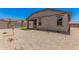 Backyard with desert landscaping, covered patio, and block wall at 18374 W Poston Dr, Surprise, AZ 85387