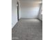 Bright bedroom featuring neutral carpet, white walls, and ample natural light at 18374 W Poston Dr, Surprise, AZ 85387