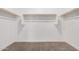 Walk-in closet featuring ample shelving and clothing rods for optimal storage solutions at 18374 W Poston Dr, Surprise, AZ 85387