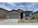 Charming single-story home with a two-car garage and low maintenance landscaping at 18374 W Poston Dr, Surprise, AZ 85387