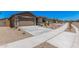 Street view of single-story homes with low maintenance yards, concrete driveway, and neutral tones at 18374 W Poston Dr, Surprise, AZ 85387