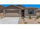 Charming single-story home featuring a low maintenance yard and a two-car garage at 18374 W Poston Dr, Surprise, AZ 85387