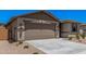 Charming single-story home featuring a low maintenance yard and a two-car garage at 18374 W Poston Dr, Surprise, AZ 85387
