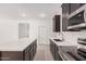 Contemporary kitchen featuring a large island, stainless steel appliances, and elegant wood-look flooring at 18374 W Poston Dr, Surprise, AZ 85387