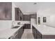 Modern kitchen with stainless steel appliances, white countertops, gray cabinets, and tile backsplash at 18374 W Poston Dr, Surprise, AZ 85387