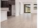 Bright living room with an open floor plan and wood-look tile flooring throughout at 18374 W Poston Dr, Surprise, AZ 85387