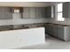 Bright kitchen features abundant gray cabinetry, neutral paint, and plenty of natural light at 20756 N 224Th Ave, Surprise, AZ 85387
