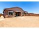 Rear exterior view of home with a dirt yard and covered patio at 21845 E Bonanza Ct, Queen Creek, AZ 85142