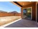 Covered patio with a view of the spacious dirt backyard and surrounding block fence at 21845 E Bonanza Ct, Queen Creek, AZ 85142