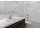 A bathroom featuring double sinks, sleek cabinets, a mirror, and a tub with shower at 21845 E Bonanza Ct, Queen Creek, AZ 85142