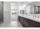 Bathroom with double sinks and dark cabinets at 21845 E Bonanza Ct, Queen Creek, AZ 85142