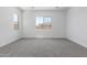 Bright bedroom with a large window and neutral carpeting at 21845 E Bonanza Ct, Queen Creek, AZ 85142