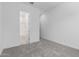 Bedroom view showcases neutral carpet, an open door, and light painted walls at 21845 E Bonanza Ct, Queen Creek, AZ 85142