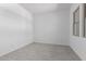 Bright, minimalist bedroom with light tile flooring, neutral walls, and a window for natural light at 21845 E Bonanza Ct, Queen Creek, AZ 85142