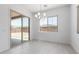 Elegant dining room with a modern chandelier, light tile flooring, and a sliding glass door to the outdoor area at 21845 E Bonanza Ct, Queen Creek, AZ 85142