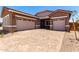 Charming single-story home featuring a paver driveway and two-car garage at 21845 E Bonanza Ct, Queen Creek, AZ 85142