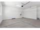 Garage features concrete floor, white walls, water heater, and garage door opener at 21845 E Bonanza Ct, Queen Creek, AZ 85142