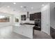 Contemporary kitchen with a center island, stainless steel appliances, dark wood cabinets, and abundant recessed lighting at 21845 E Bonanza Ct, Queen Creek, AZ 85142