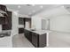 Bright, open kitchen showcasing a center island with bar seating, sleek stainless steel appliances, and ample cabinet space at 21845 E Bonanza Ct, Queen Creek, AZ 85142